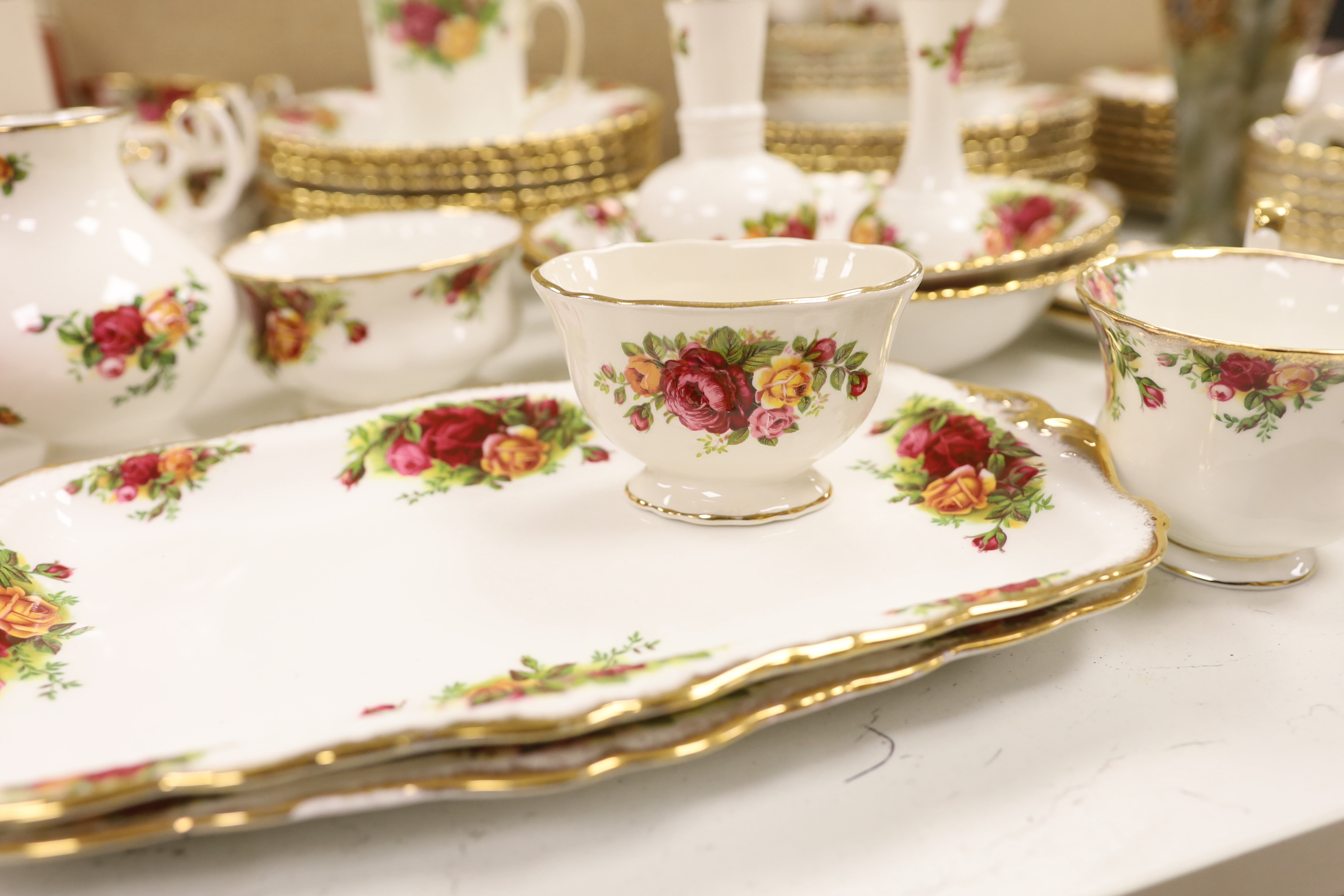 A Royal Albert Old Crown Roses dinner and tea service and a Doulton Lambeth vase